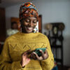 Young woman using the mobile phone at home